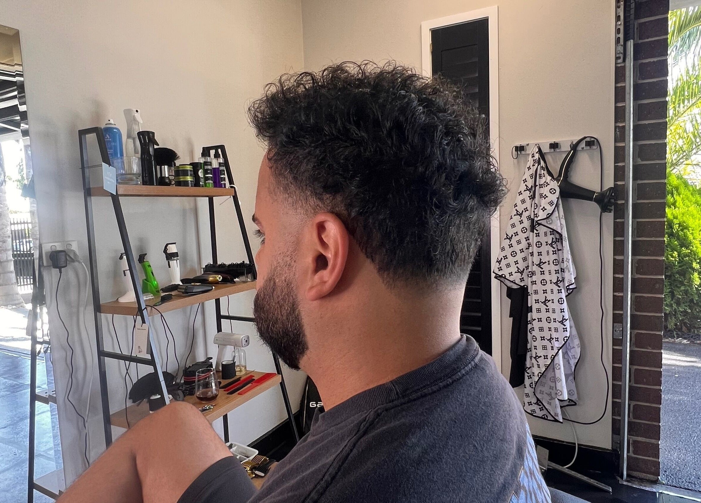 Client with fresh haircut at Chuckz Cutz, Melbourne, Victoria, AU, showcasing modern barber style.