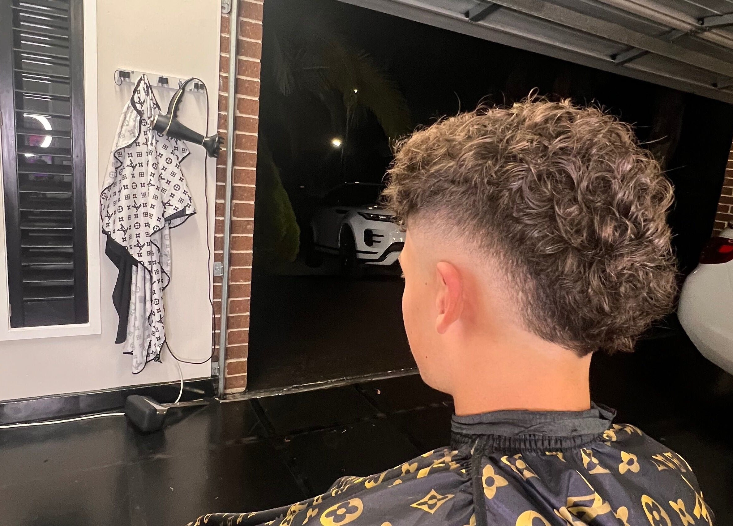 Curly haircut with fade at Chuckz Cutz, Melbourne, Victoria, AU showing modern styling.