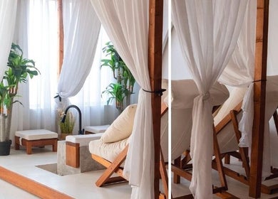 Relaxing massage area at Bokla Salon & Spa, Al Khobar, Eastern Province, SA with wooden decor and lush greenery.