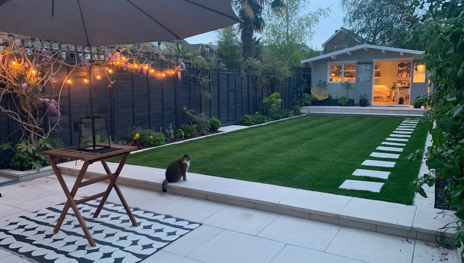 Tranquil garden at Refresh Skin and Body, Salisbury, England, GB, featuring evening lights and wellness cabin.