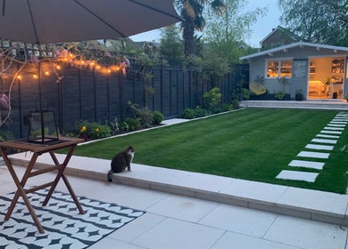 Tranquil garden at Refresh Skin and Body, Salisbury, England, GB, featuring evening lights and wellness cabin.