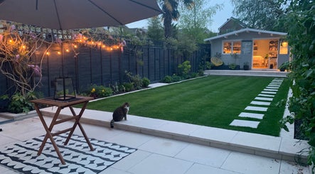 Tranquil garden at Refresh Skin and Body, Salisbury, England, GB, featuring evening lights and wellness cabin.