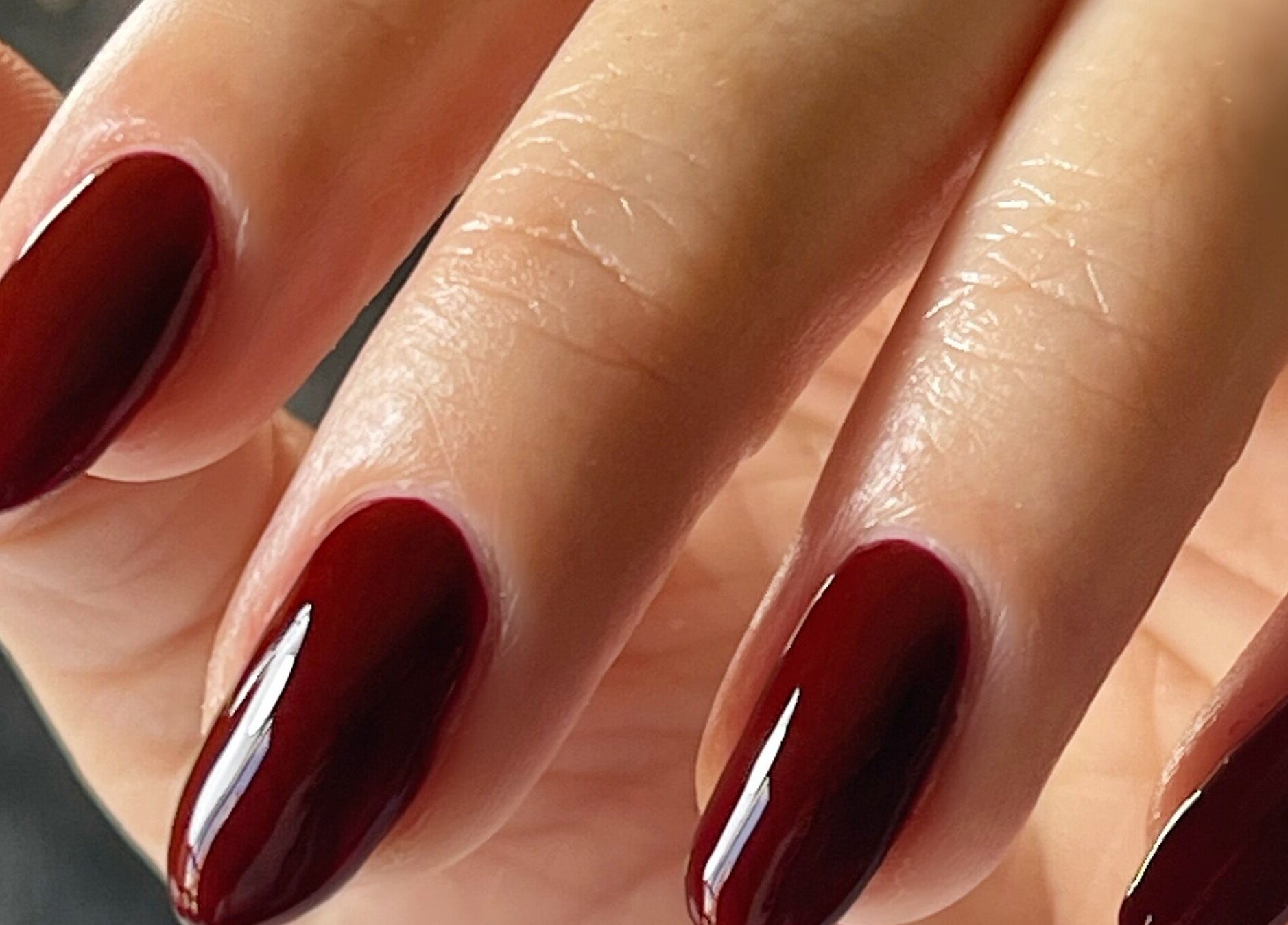 Close-up of manicured nails with deep red polish from Refresh Skin and Body, Salisbury, England, GB.