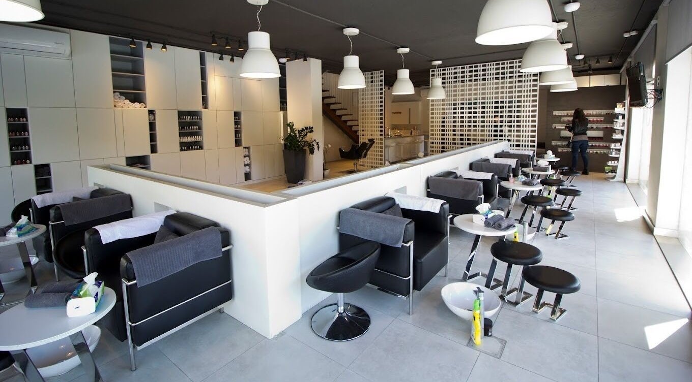 Modern interior of Nail Boutique in Amman, Amman Governorate, JO, featuring sleek nail stations.