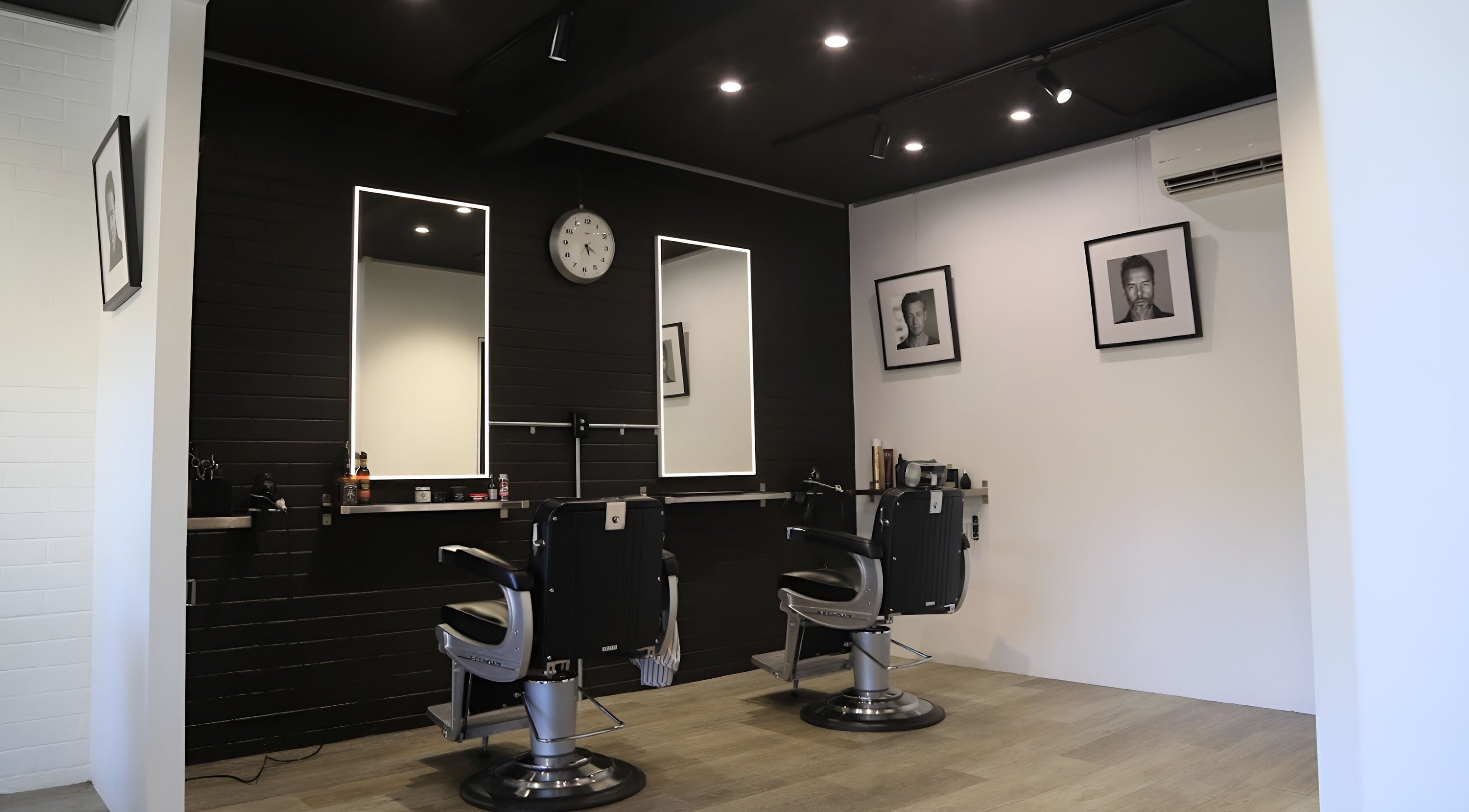 Elegant interior of JK Barber Room in Kenmore, Queensland, AU, showcasing modern barber chairs and stylish decor.