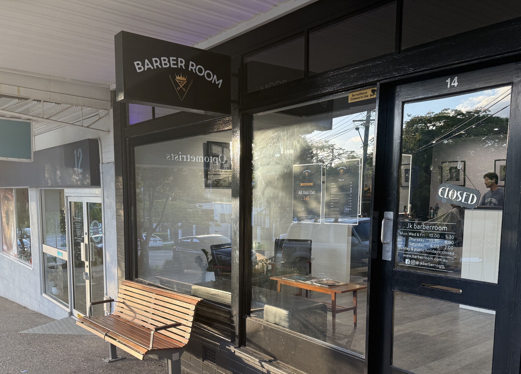 Entrance of JK Barber Room in Kenmore, Queensland, AU, showcasing sleek exterior design.
