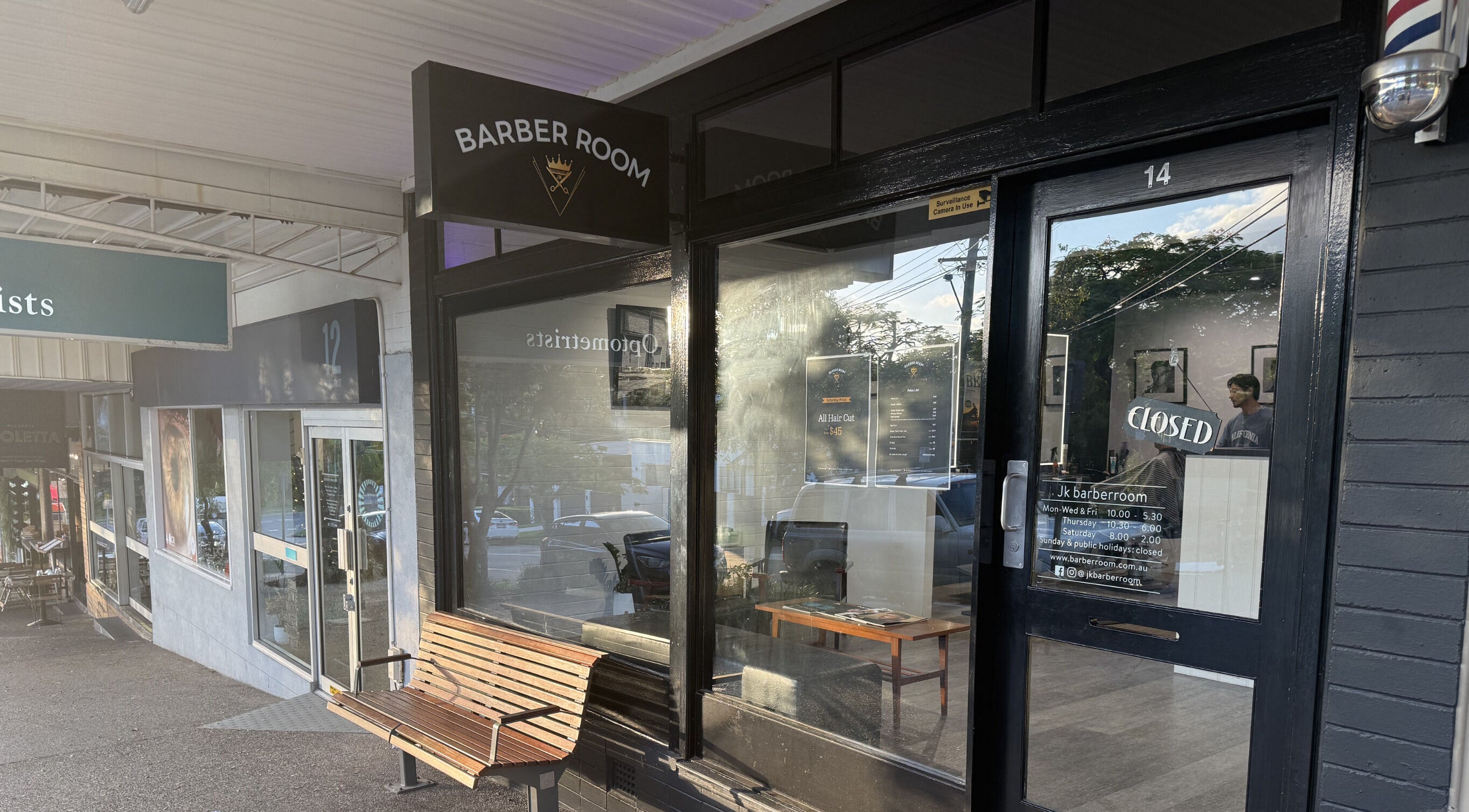 Entrance of JK Barber Room in Kenmore, Queensland, AU, showcasing sleek exterior design.