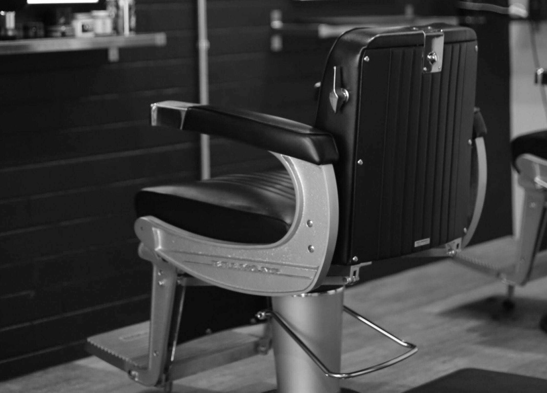 Comfortable barber chair at JK Barber Room, Kenmore, Queensland, AU, showcasing sleek modern design.