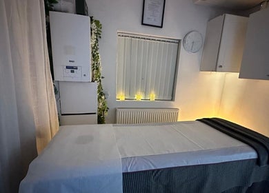 Tranquil massage room at Cosmic Beauty & Wellness (Mia Elegance Nails) in London, England, GB illuminated softly.