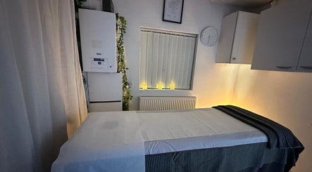 Tranquil massage room at Cosmic Beauty & Wellness (Mia Elegance Nails) in London, England, GB illuminated softly.