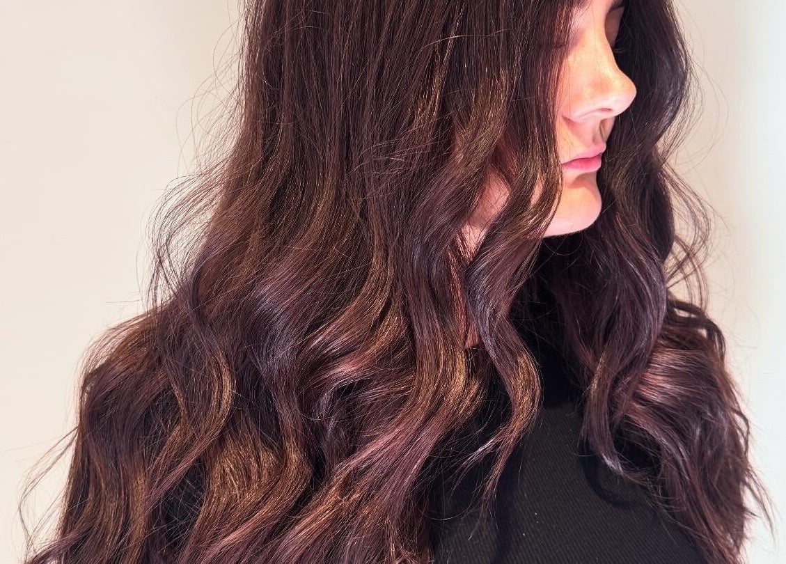 Side profile of wavy brunette hair styled at The Olive Room, Newbury, England, GB.