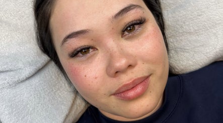 Close-up of a woman with radiant skin and eyelash extensions at Johnny's Makeover Home Salon, Rothwell, Queensland, AU.