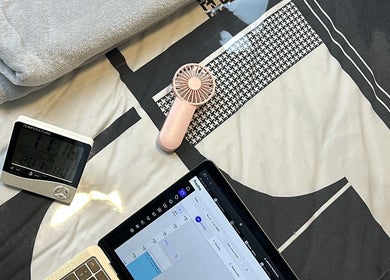 Cozy setup at Johnny's Makeover Home Salon in Rothwell, Queensland with fan, tablet, and blanket.
