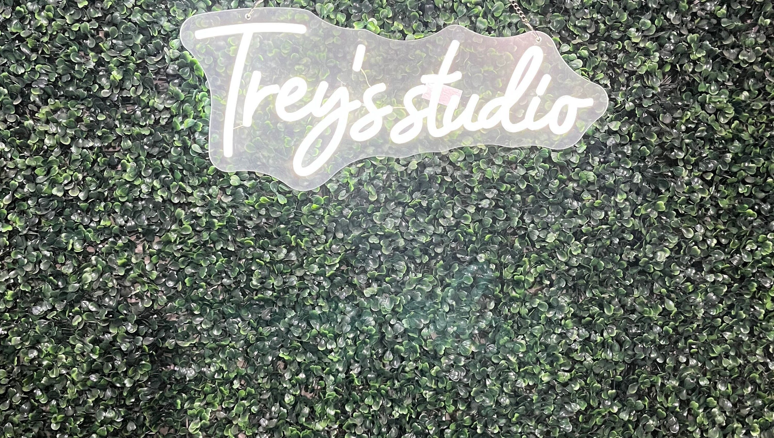 Treys Studio Clau-clau Mpumalanga ZA logo on lush green backdrop.