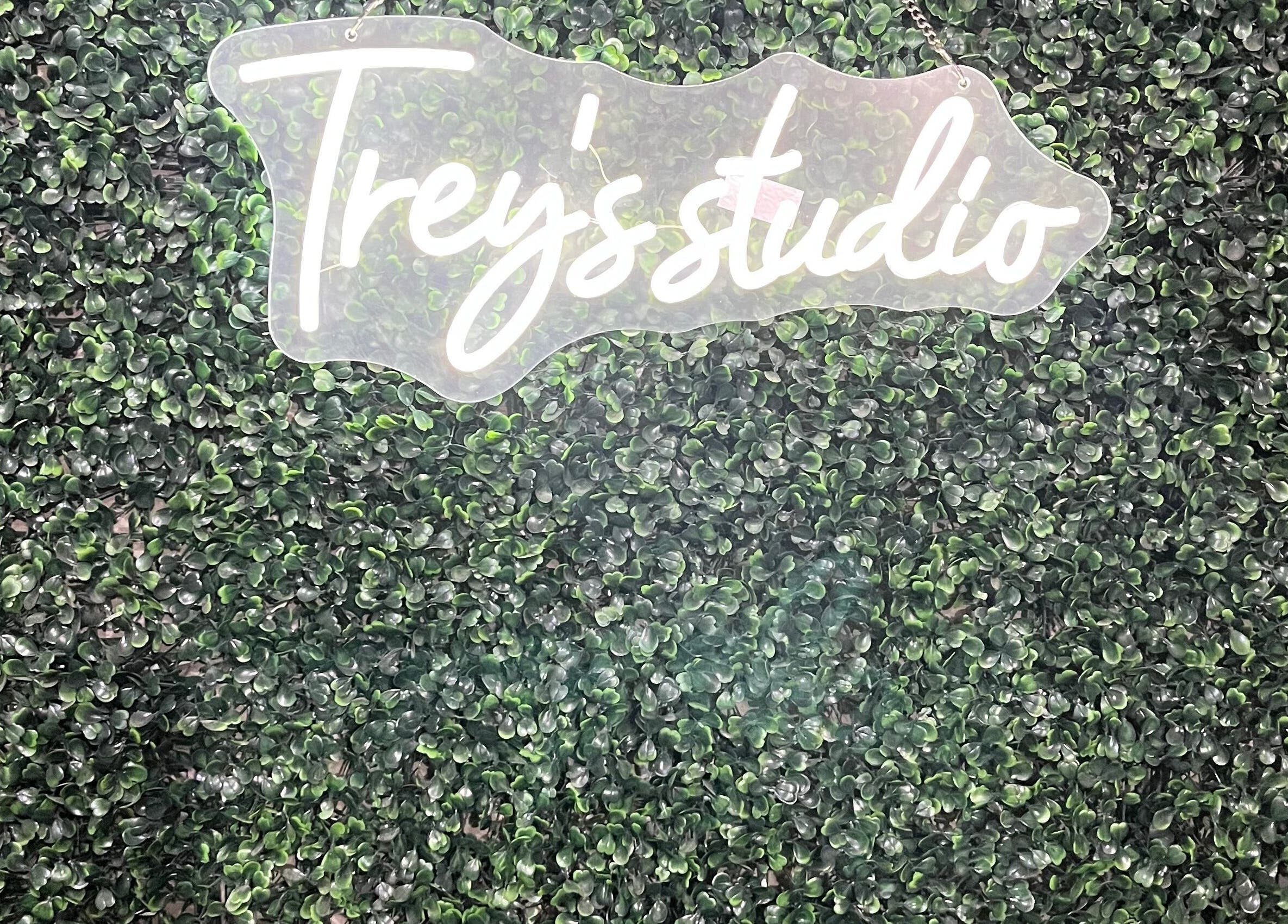 Treys Studio Clau-clau Mpumalanga ZA logo on lush green backdrop.