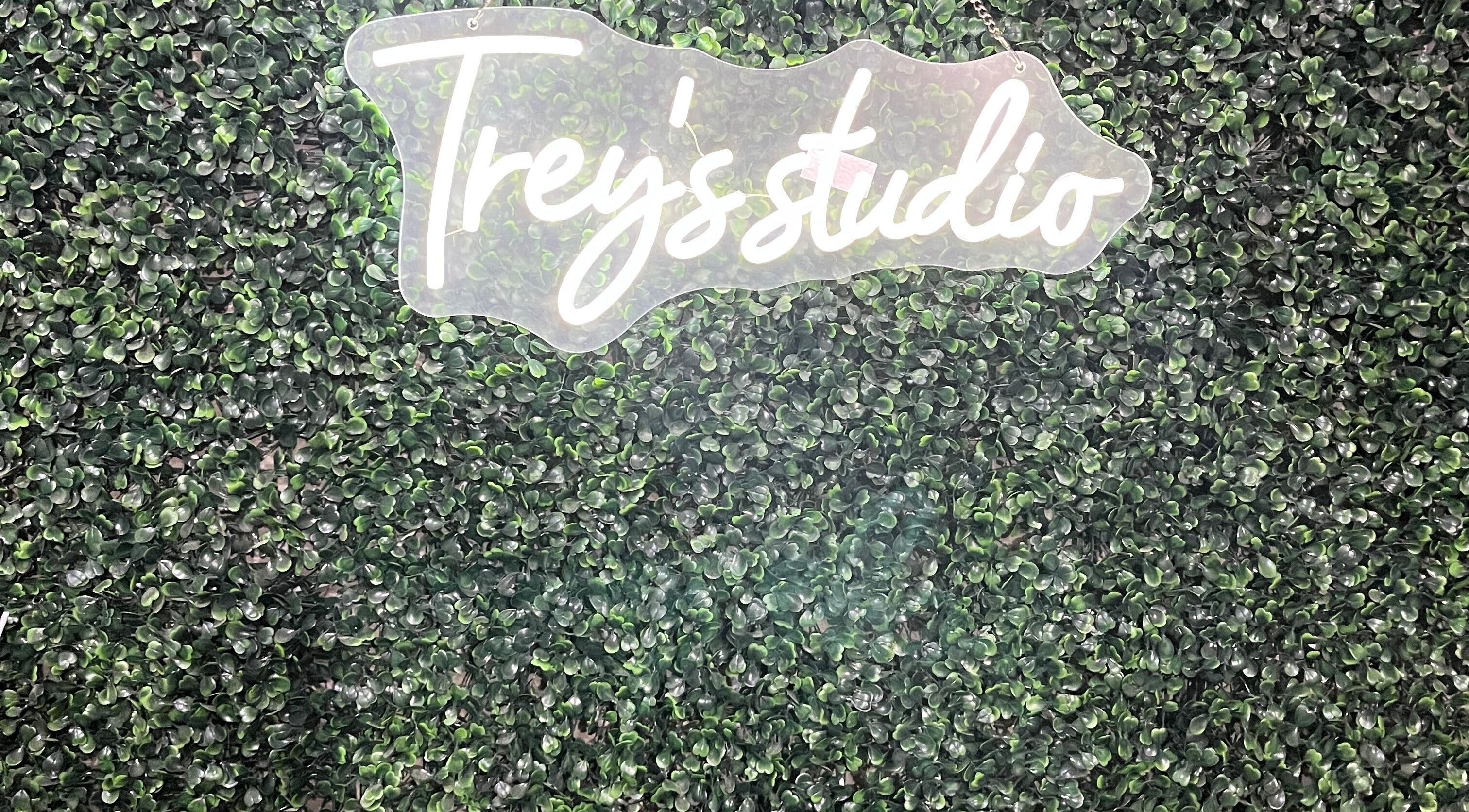 Treys Studio Clau-clau Mpumalanga ZA logo on lush green backdrop.