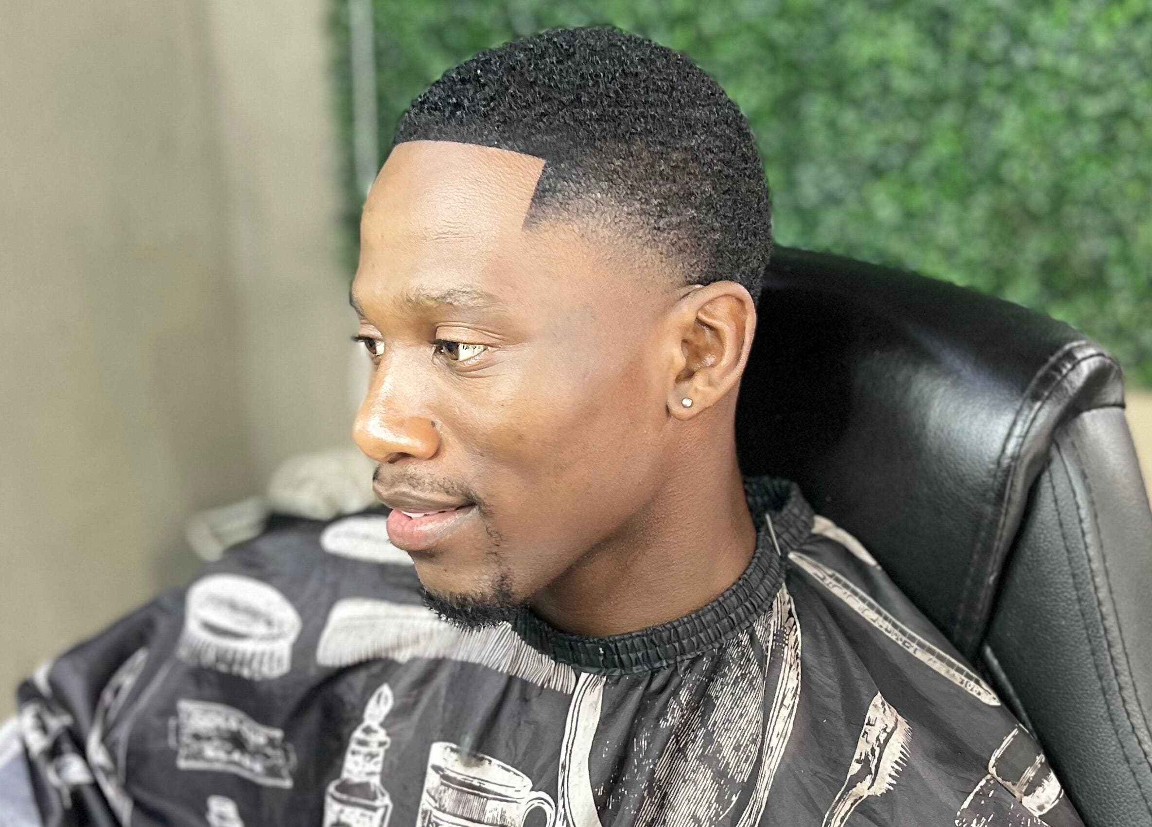 Client with a fresh haircut at Treys Studio, Clau-clau, Mpumalanga, ZA, showcasing expert grooming.