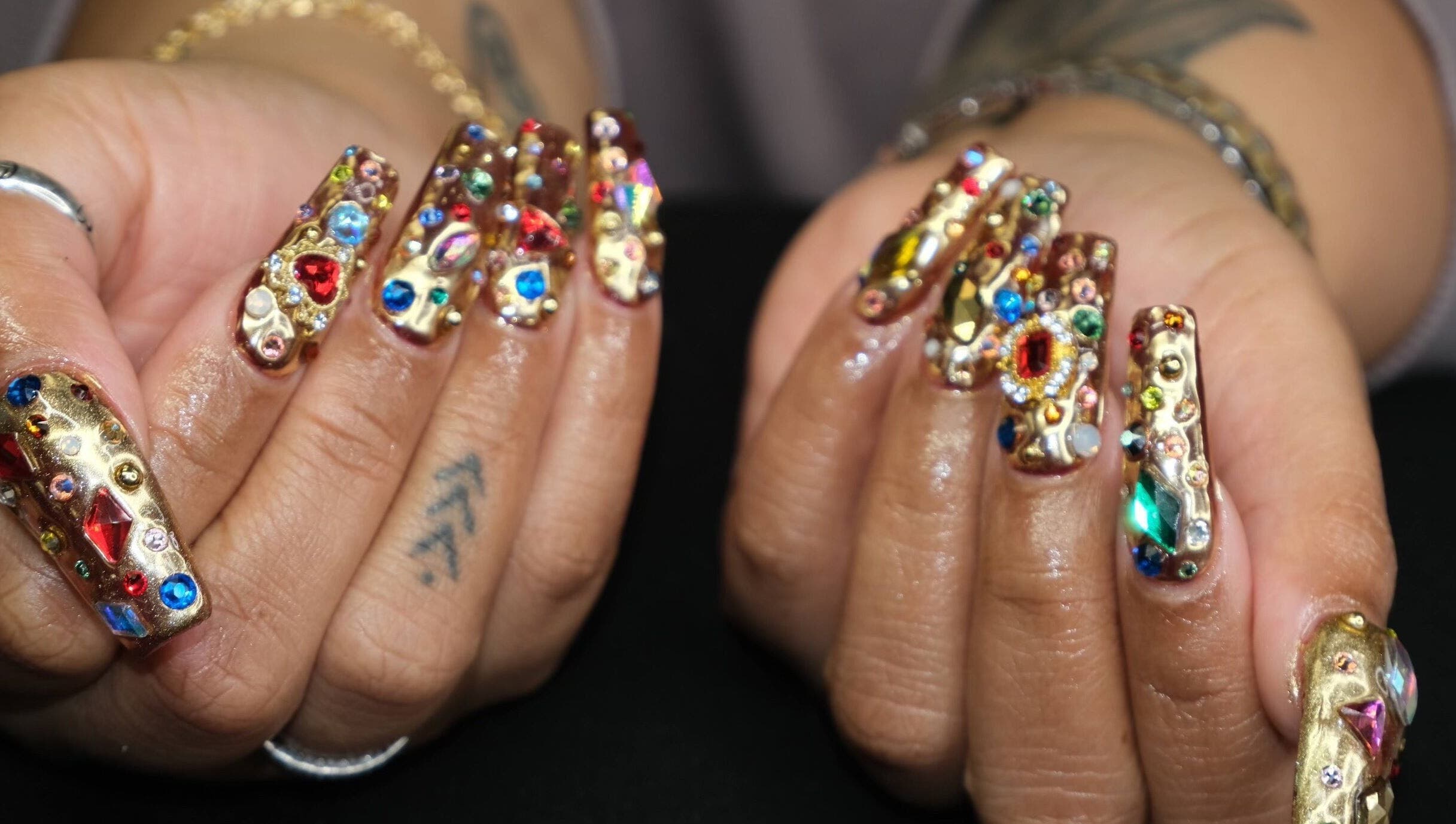 Exquisite gemstone nail art by Naild By Tee in Chicago Heights, Illinois, US, showcasing colorful gems.