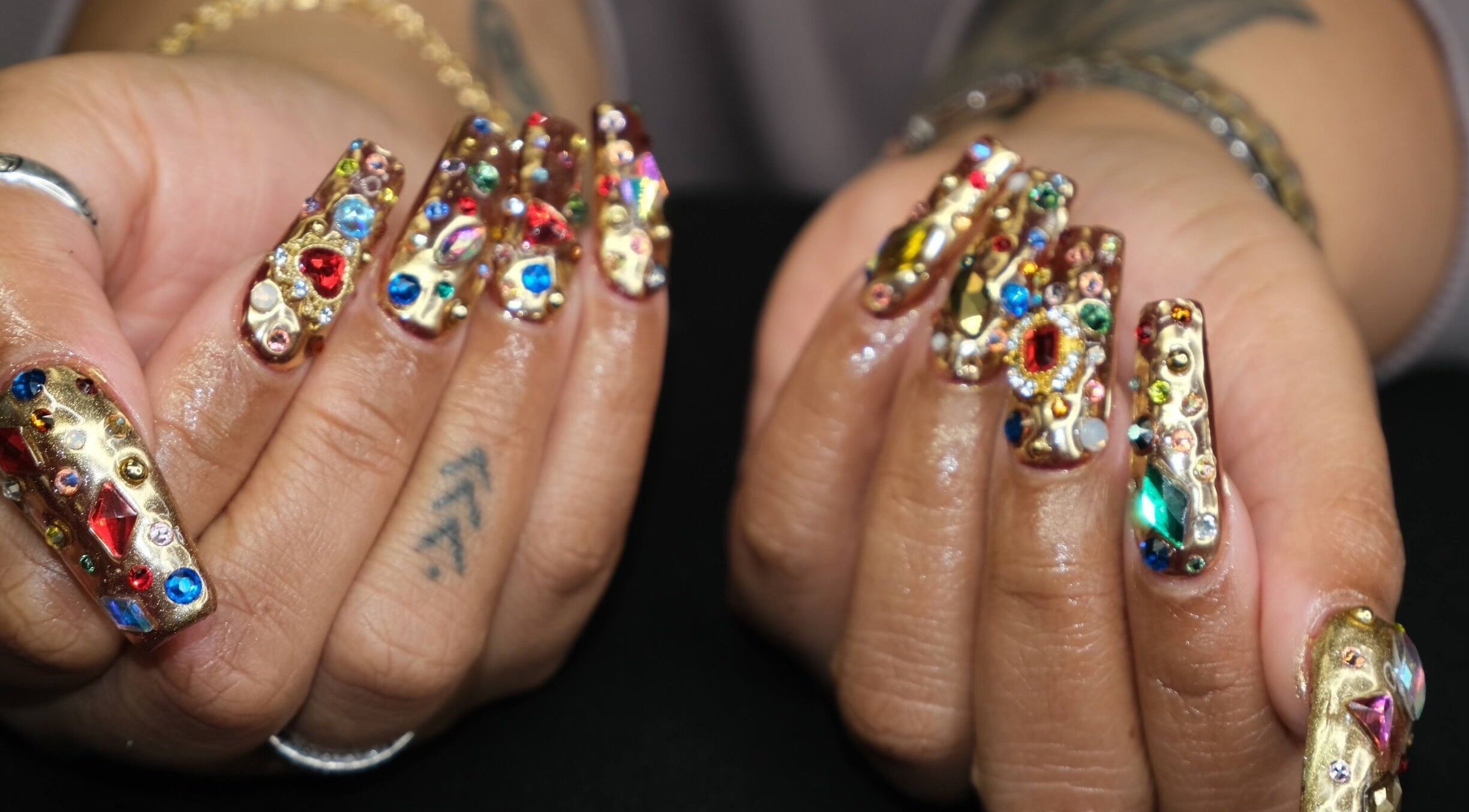 Exquisite gemstone nail art by Naild By Tee in Chicago Heights, Illinois, US, showcasing colorful gems.