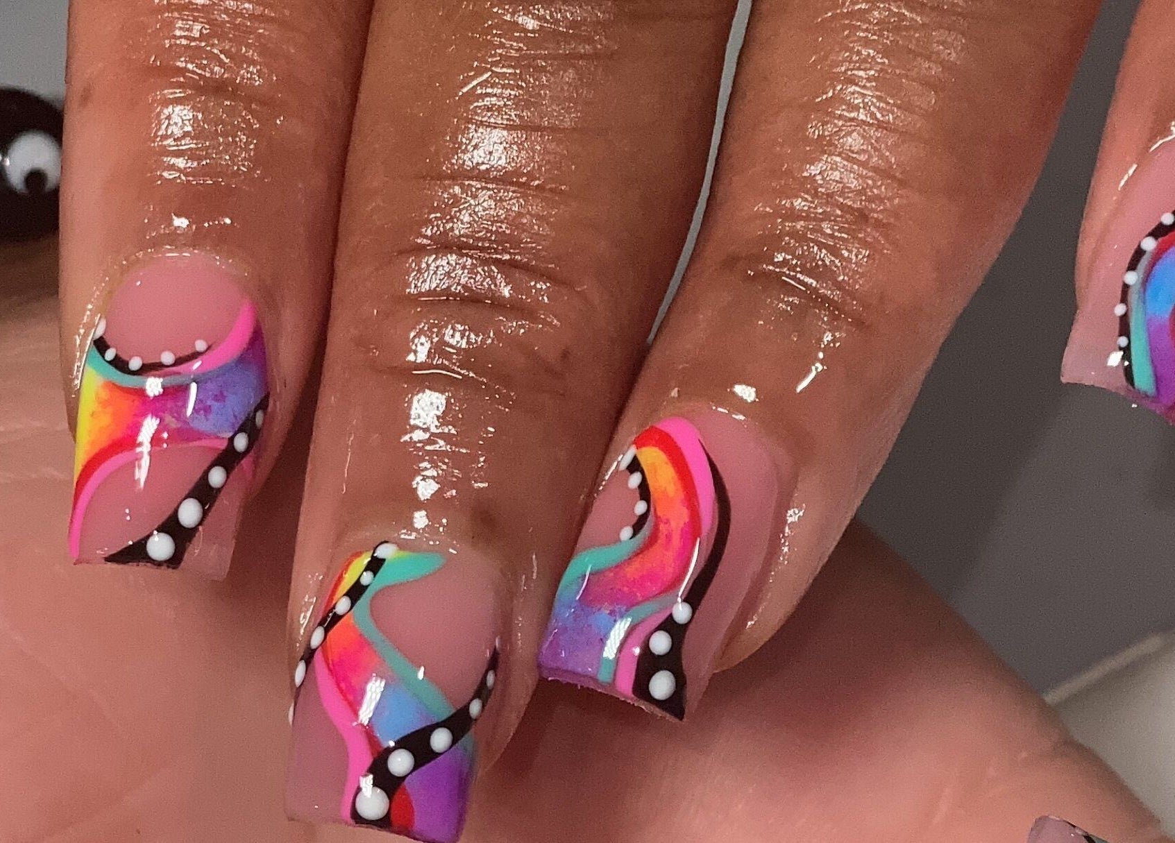 Colorful nail art at Naild By Tee in Chicago Heights, Illinois, US showcasing intricate designs on manicured nails.