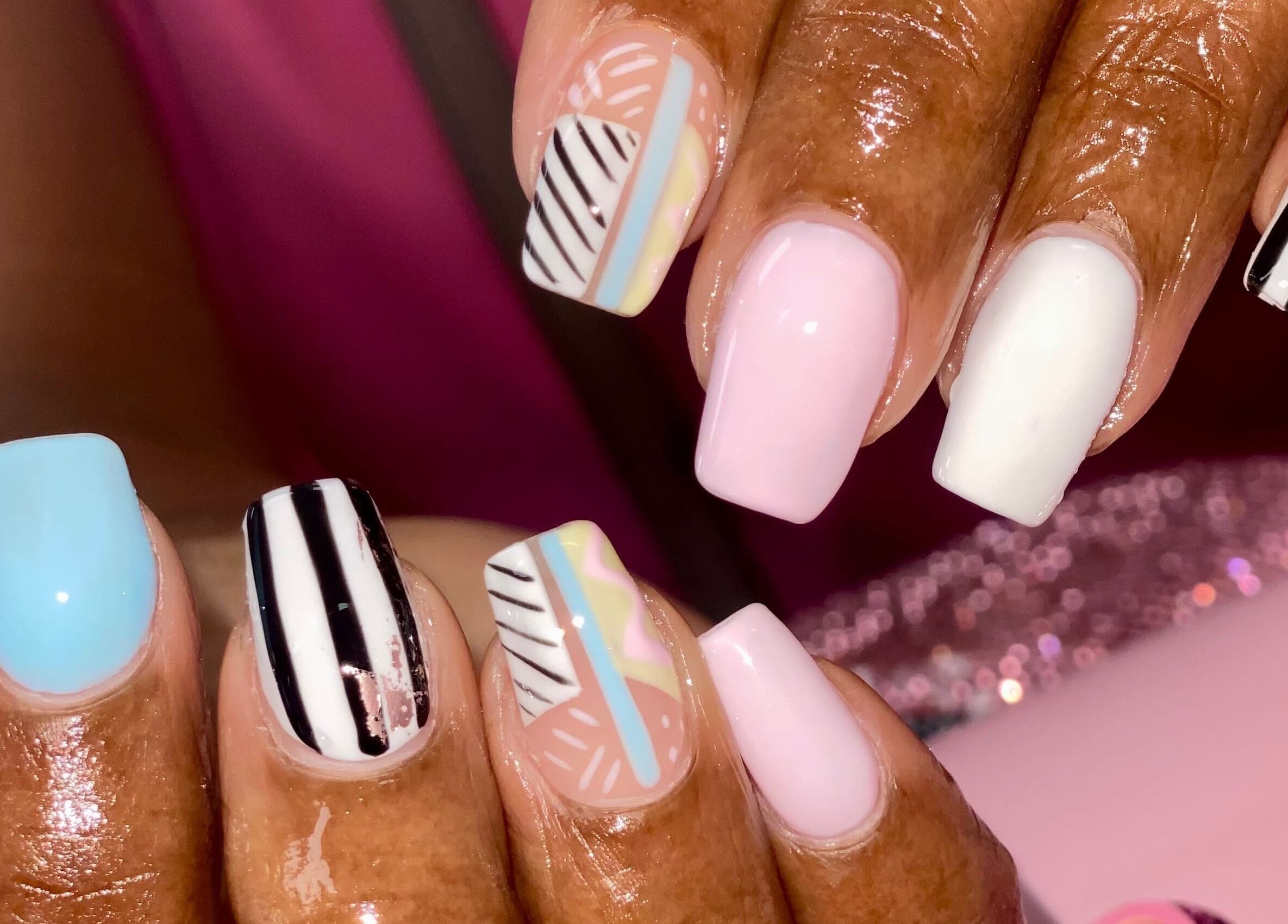 Stylish nail art design at Naild By Tee in Chicago Heights, Illinois, US featuring vibrant colors and geometric patterns.