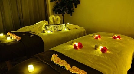Peaceful massage room setup at Thai House Wellness and Spa, Sacramento, California, US with candles and flowers.