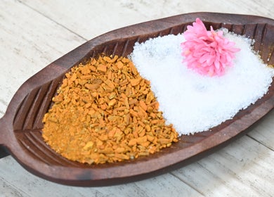 Herbal and salt spa dish at Thai House Wellness and Spa, Sacramento, California, US with pink flower accent.