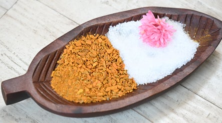 Herbal and salt spa dish at Thai House Wellness and Spa, Sacramento, California, US with pink flower accent.
