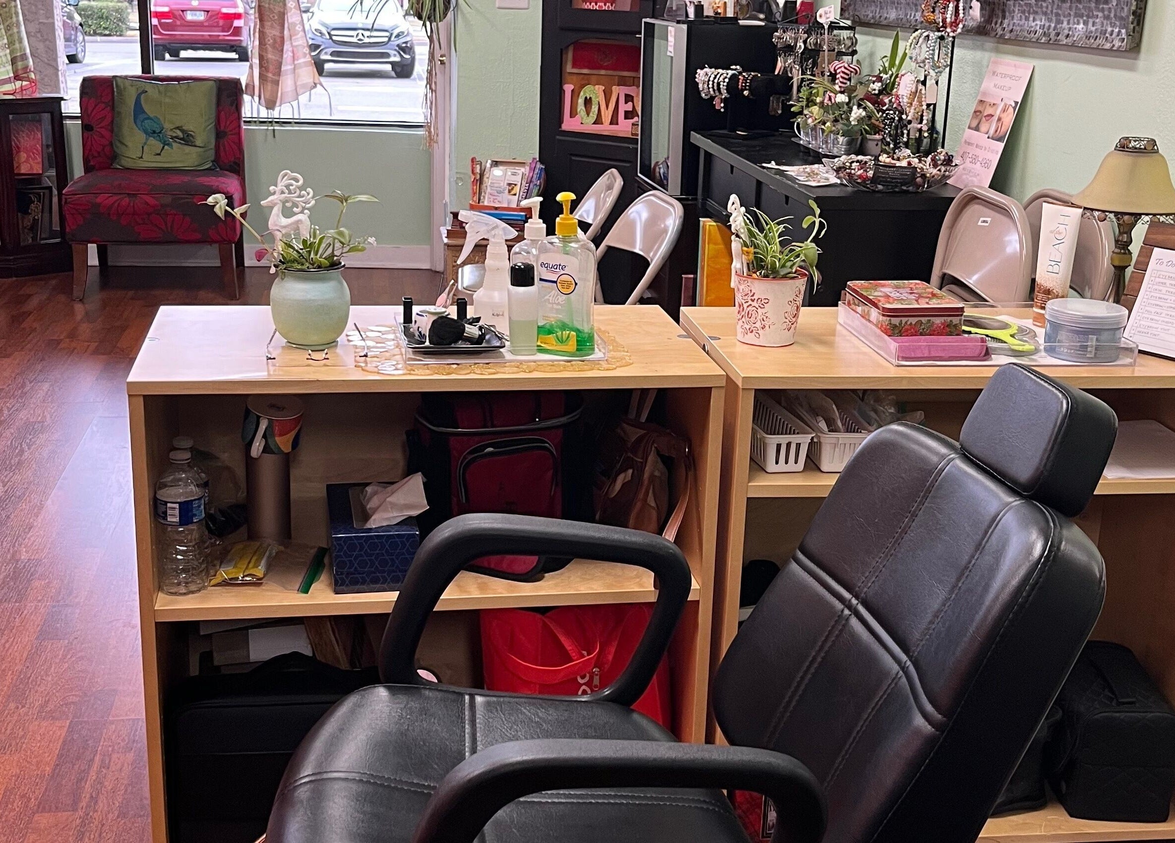 Cozy nail station at Vida Beauty Brow, Altamonte Springs, Florida, US with chairs, plants, and beauty products.
