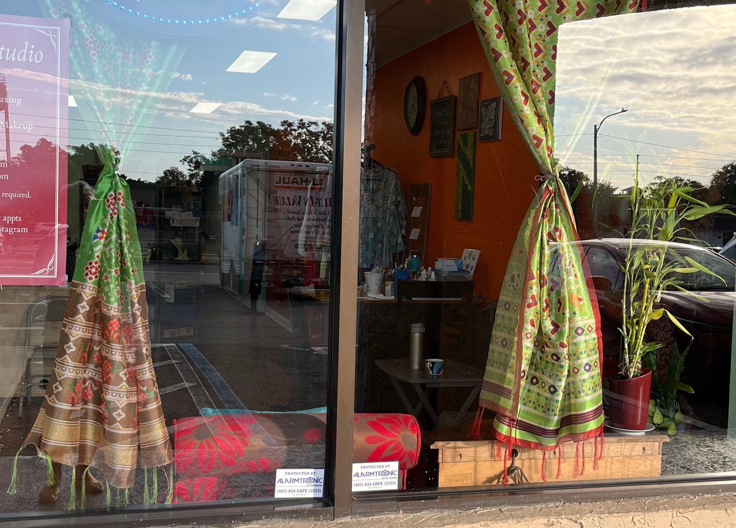 Chic storefront of Vida Beauty Brow in Altamonte Springs, Florida, US, featuring vibrant drapes and potted plants.