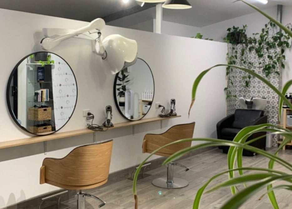 Elegant salon setup at Studio Hi Gorgeous, Alfredton, Victoria, AU featuring round mirrors and contemporary chairs.