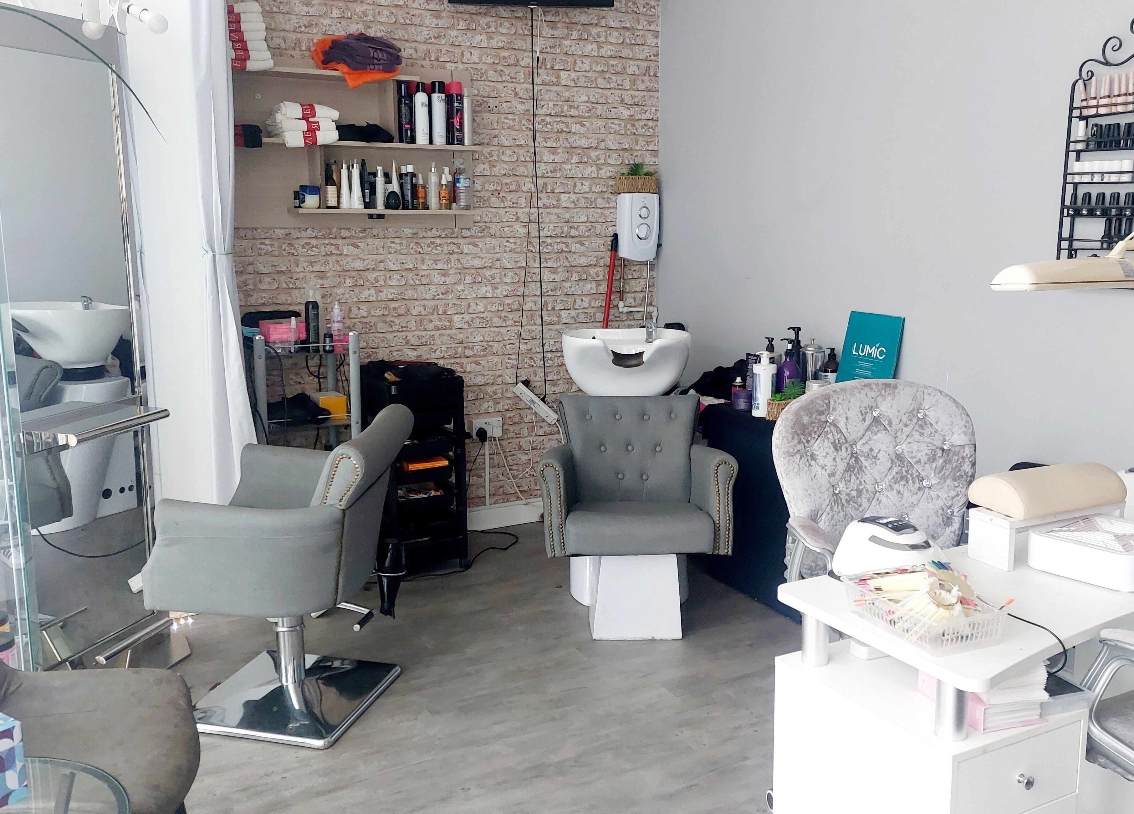 Modern beauty salon interior at Palmarys, Southampton, England, GB featuring stylish chairs and beauty station.