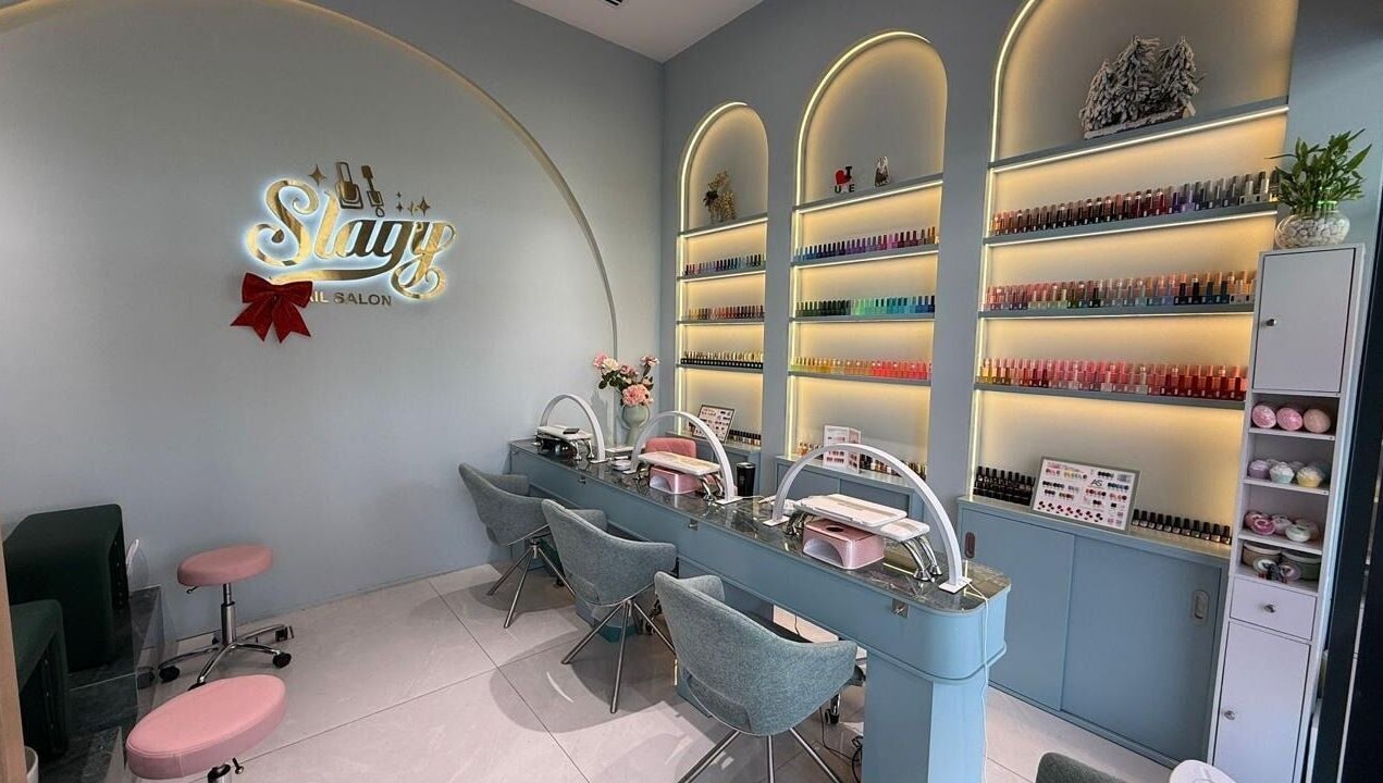 Chic Slayy Nails salon interior in Dubai, Dubai, AE, showcasing stylish decor and nail polish collection.