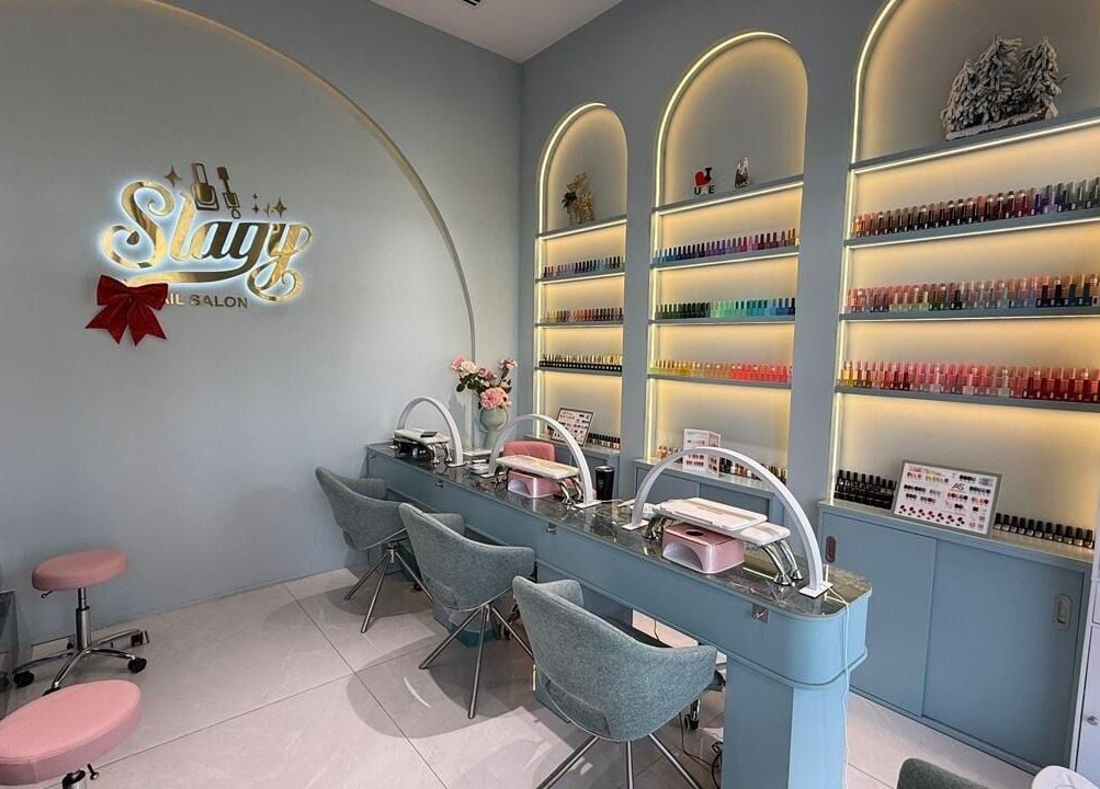 Chic Slayy Nails salon interior in Dubai, Dubai, AE, showcasing stylish decor and nail polish collection.