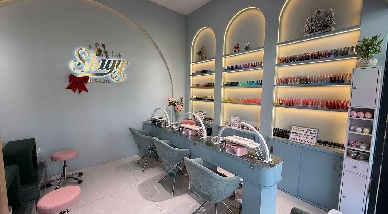 Chic Slayy Nails salon interior in Dubai, Dubai, AE, showcasing stylish decor and nail polish collection.
