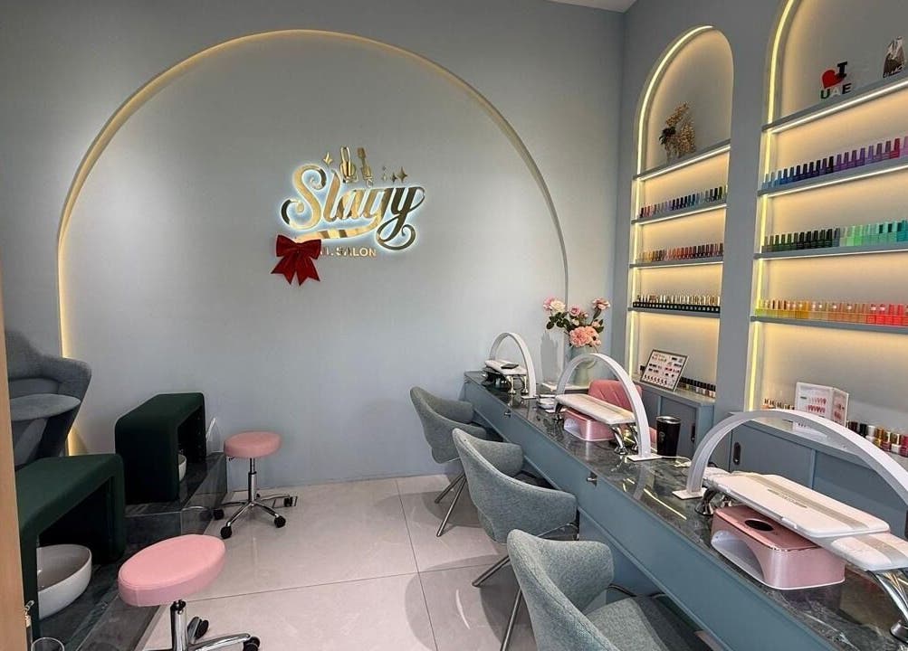 Elegant interior of Slayy Nails, Dubai with modern nail stations and color displays. Located in Dubai, Dubai, AE.