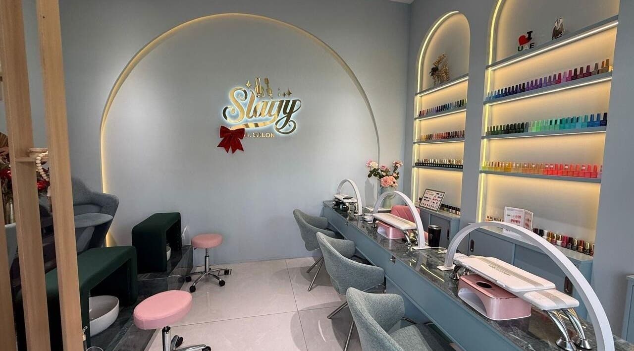 Elegant interior of Slayy Nails, Dubai with modern nail stations and color displays. Located in Dubai, Dubai, AE.