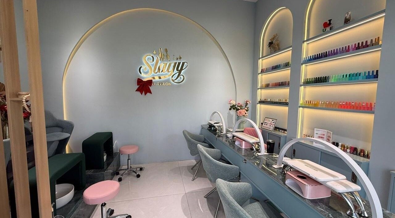 Elegant interior of Slayy Nails, Dubai with modern nail stations and color displays. Located in Dubai, Dubai, AE.