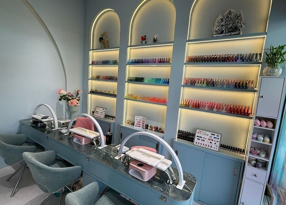 Elegant nail studio at Slayy Nails, Dubai, Dubai, AE with stylish chairs and vibrant polish display.