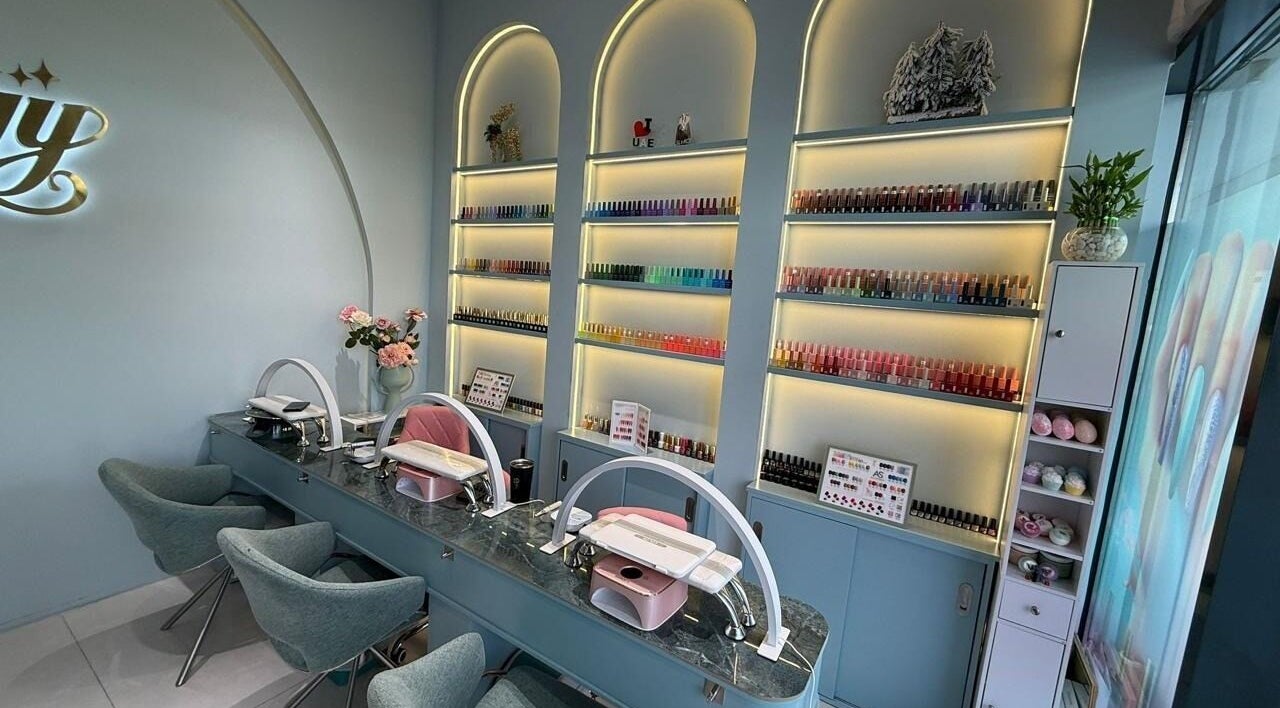 Elegant nail studio at Slayy Nails, Dubai, Dubai, AE with stylish chairs and vibrant polish display.