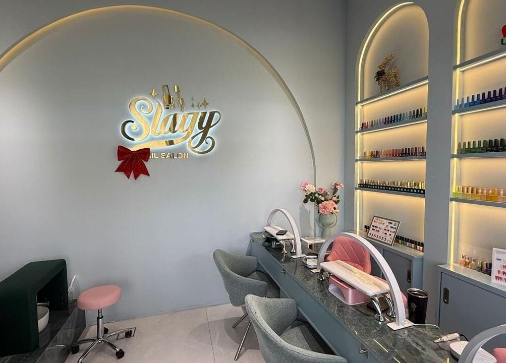 Modern nail salon interior at Slayy Nails in Dubai, Dubai, AE with stylish decor and vibrant nail polish display.