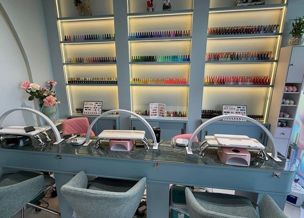 Bright, modern nail salon interior at Slayy Nails in Dubai, Dubai, AE, showcasing vibrant polish display.