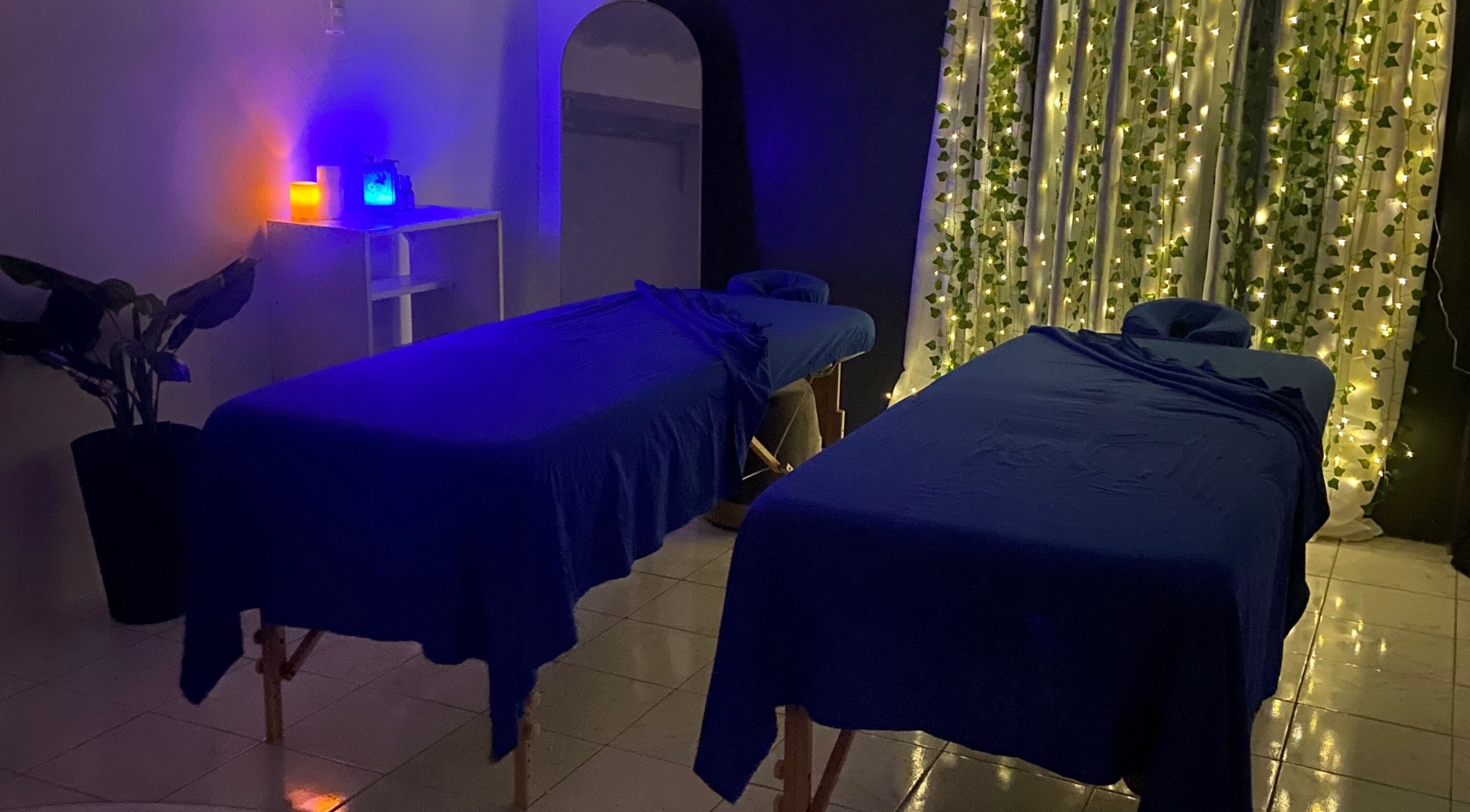 Relaxing massage room at The Wellness Haven, Tunapuna/Piarco Regional Corporation, TT adorned with tranquil lighting.