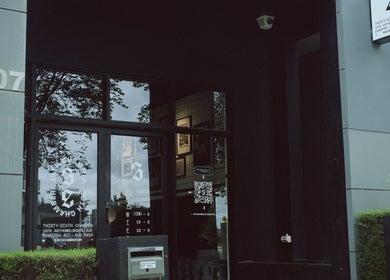 Entrance of 36th Chamber in Gungahlin, Australian Capital Territory, AU, with glass door and signage.