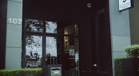 Entrance of 36th Chamber in Gungahlin, Australian Capital Territory, AU, with glass door and signage.