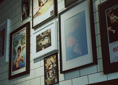 Framed posters and artwork on wall at 36th Chamber, Gungahlin, Australian Capital Territory, AU.