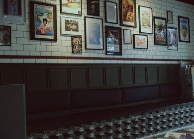 Artistic wall decor in 36th Chamber, Gungahlin, Australian Capital Territory, AU with retro posters.