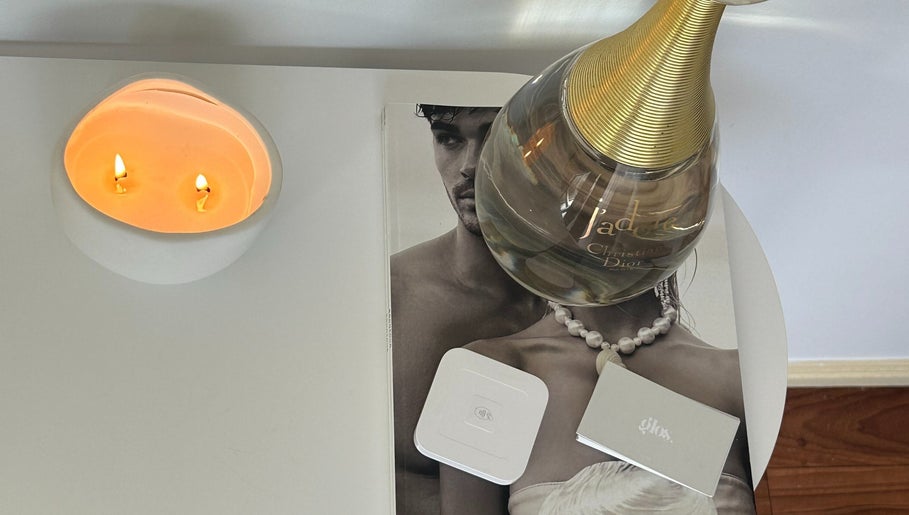 Elegant display with a candle and perfume at Glos Skin & Beauty, Helensvale, Queensland, AU.