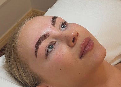 Client receiving eyebrow treatment at Glos Skin & Beauty in Helensvale, Queensland, AU.