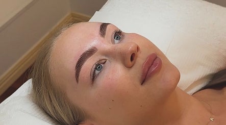Client receiving eyebrow treatment at Glos Skin & Beauty in Helensvale, Queensland, AU.
